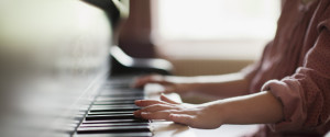 Close up of girl's hands on piano